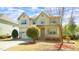 Inviting two-story home with a well-maintained lawn, an attached garage and a quaint front porch at 504 Prince Dr, Holly Springs, NC 27540