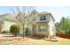 Charming two-story home featuring a welcoming front porch and a neatly landscaped yard at 504 Prince Dr, Holly Springs, NC 27540