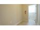 Well-lit hallway with neutral paint leads to a powder room at 504 Prince Dr, Holly Springs, NC 27540