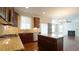 Spacious kitchen features stainless appliances, granite countertops, and island, adjacent to living room at 504 Prince Dr, Holly Springs, NC 27540