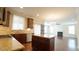 Open concept kitchen and living area with dark cabinets, granite countertops, and hardwood floors at 504 Prince Dr, Holly Springs, NC 27540