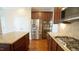 Bright kitchen with stainless steel appliances, a granite island, and double ovens at 504 Prince Dr, Holly Springs, NC 27540