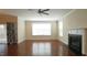 Bright living room featuring hardwood floors, fireplace, and lots of natural light at 504 Prince Dr, Holly Springs, NC 27540
