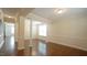 Open-concept living area boasts hardwood floors, large windows, and classic columns at 504 Prince Dr, Holly Springs, NC 27540