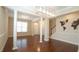 Open living room featuring hardwood floors, elegant columns, and ample natural light at 504 Prince Dr, Holly Springs, NC 27540