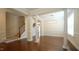 Large room boasts hardwood floors, classic columns, a staircase and abundant natural light at 504 Prince Dr, Holly Springs, NC 27540