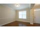 Well-lit room features hardwood floors, large window and entry door at 504 Prince Dr, Holly Springs, NC 27540