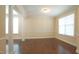 Bright living room with hardwood floors, classic columns, and ample natural light at 504 Prince Dr, Holly Springs, NC 27540