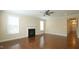 Bright living room with a fireplace, hardwood floors, and access to the foyer at 504 Prince Dr, Holly Springs, NC 27540