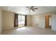 Spacious main bedroom with tray ceiling, large windows, and ensuite bathroom at 504 Prince Dr, Holly Springs, NC 27540
