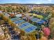 Scenic aerial shot of the community amenities, including the pool, tennis courts, and green spaces at 507 Parkside Cir, Chapel Hill, NC 27516