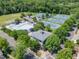 Aerial view of community pool and tennis courts with lush green landscaping and mature trees at 507 Parkside Cir, Chapel Hill, NC 27516