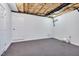 Unfinished basement featuring open ceiling, pegboard wall and carpet flooring at 507 Parkside Cir, Chapel Hill, NC 27516