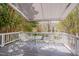 Covered deck with comfortable seating and lush greenery at 507 Parkside Cir, Chapel Hill, NC 27516
