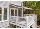 Charming deck with white railings, outdoor seating, and a retractable awning at 507 Parkside Cir, Chapel Hill, NC 27516