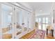Inviting foyer with hardwood floors, a colorful rug, and glass paneled doors leading to an office space at 507 Parkside Cir, Chapel Hill, NC 27516