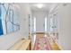 Inviting foyer with hardwood floors, a colorful rug, and glass paneled doors leading to an office space at 507 Parkside Cir, Chapel Hill, NC 27516