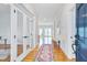 Inviting foyer with hardwood floors, a colorful rug, and glass paneled doors leading to an office space at 507 Parkside Cir, Chapel Hill, NC 27516