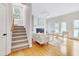 Bright living room featuring hardwood floors, fireplace, and French doors leading to the backyard at 507 Parkside Cir, Chapel Hill, NC 27516