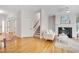 Bright living room featuring a fireplace, hardwood floors, and a staircase leading to the upper level at 507 Parkside Cir, Chapel Hill, NC 27516