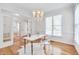 Bright office with hardwood floors, a chandelier, and ample natural light through the windows at 507 Parkside Cir, Chapel Hill, NC 27516
