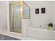Bright bathroom featuring a shower and separate bathtub with tile surround at 537 Chatham Dr, Chapel Hill, NC 27516