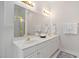 Bathroom with double vanity, gold fixtures, and shower at 537 Chatham Dr, Chapel Hill, NC 27516