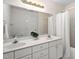 Bathroom with double vanity sink, decorative mirror, and shower at 537 Chatham Dr, Chapel Hill, NC 27516