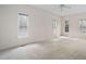 Bright bedroom featuring three large windows and neutral carpeting at 537 Chatham Dr, Chapel Hill, NC 27516