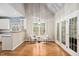 Cozy breakfast nook with hardwood floors, large windows, and stylish lighting fixture near the modern kitchen at 537 Chatham Dr, Chapel Hill, NC 27516