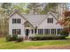 This two-story home features beautiful landscaping and a classic facade with black shutters at 537 Chatham Dr, Chapel Hill, NC 27516