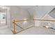 Upstairs hallway with carpet flooring and wooden handrail at 537 Chatham Dr, Chapel Hill, NC 27516