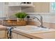 Close-up of the kitchen sink with modern fixtures and a view of the breakfast nook at 537 Chatham Dr, Chapel Hill, NC 27516