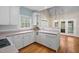 Bright kitchen featuring white cabinetry, ample counter space, and a seamless transition to the breakfast nook at 537 Chatham Dr, Chapel Hill, NC 27516