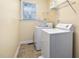 Laundry room with washer, dryer, and overhead shelving at 537 Chatham Dr, Chapel Hill, NC 27516