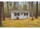Charming outbuilding nestled among the trees, featuring a quaint porch and well-maintained exterior at 537 Chatham Dr, Chapel Hill, NC 27516