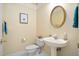 Cozy half bath featuring a pedestal sink, updated fixtures, and neutral decor at 537 Chatham Dr, Chapel Hill, NC 27516