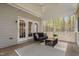 Relaxing screened-in porch with comfortable seating, ceiling fan, and view of the private backyard at 537 Chatham Dr, Chapel Hill, NC 27516