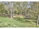 A view of the backyard, which is large with lots of trees, shade and grass at 5612 Crossfield Dr, Raleigh, NC 27613