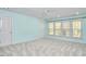 Bright bedroom with three large windows, ceiling fan, and neutral carpet at 5612 Crossfield Dr, Raleigh, NC 27613