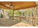 Wide angle view of the deck, with wood ceiling, ceiling fan, and outdoor railing overlooking the backyard at 5612 Crossfield Dr, Raleigh, NC 27613