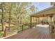 Eye-level exterior view of the deck with grill, heater, wood ceiling, and outdoor railing overlooking backyard at 5612 Crossfield Dr, Raleigh, NC 27613