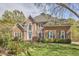 Beautiful two-story brick home featuring blue shutters and manicured landscaping at 5612 Crossfield Dr, Raleigh, NC 27613
