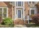 Close-up of the entryway with a blue door, brick steps, and white trim at 5612 Crossfield Dr, Raleigh, NC 27613