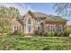 Classic brick home with a well-kept lawn and flowering trees at 5612 Crossfield Dr, Raleigh, NC 27613