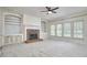 Inviting living room with a fireplace, built-in bookshelves, and large windows at 5612 Crossfield Dr, Raleigh, NC 27613