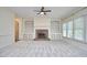 Bright living room featuring a fireplace with custom built-ins, and neutral carpet at 5612 Crossfield Dr, Raleigh, NC 27613
