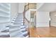 Elegant staircase with carpeted steps and wood railing leading to the upper level at 5612 Crossfield Dr, Raleigh, NC 27613