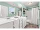Bright bathroom with dual sinks, white cabinets, and a shower-tub combination at 5989 Zacks Mill Rd, Angier, NC 27501