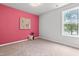 This bright bedroom offers neutral carpeting and a standout accent wall at 5989 Zacks Mill Rd, Angier, NC 27501